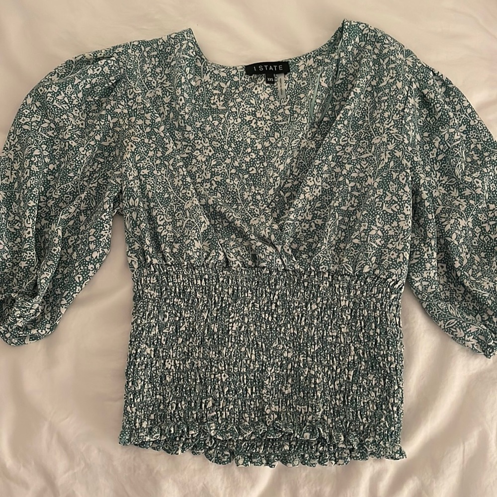 Green and white floral top.